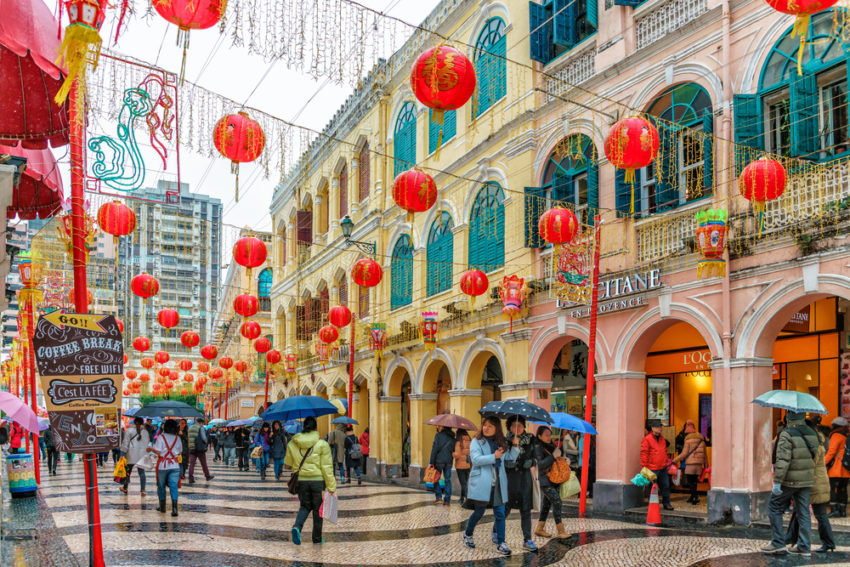 Chinese people wearing an umbrella with decorated streets (c) eWilding / shutterstock